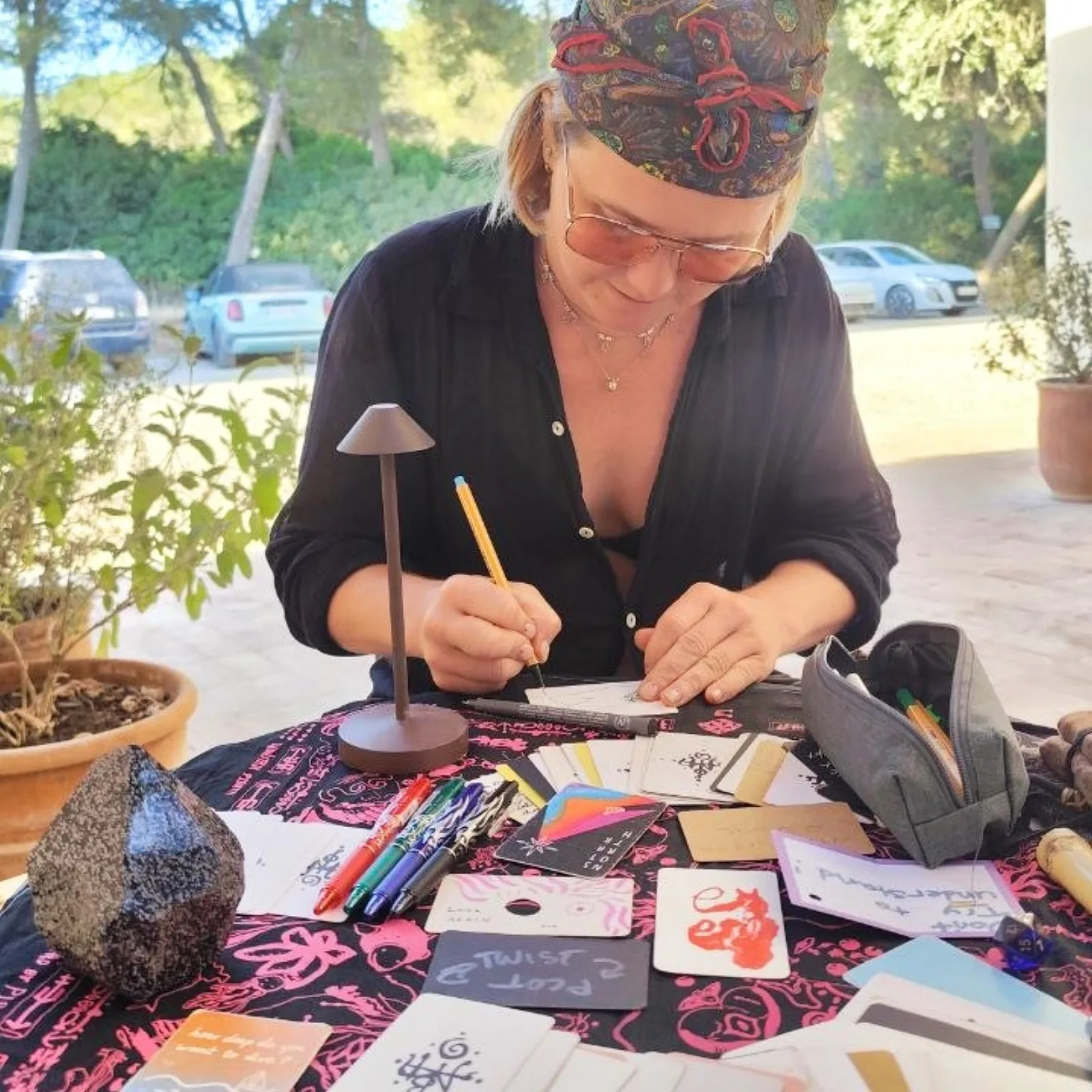 A guest drawing her own card at an outdoor session table